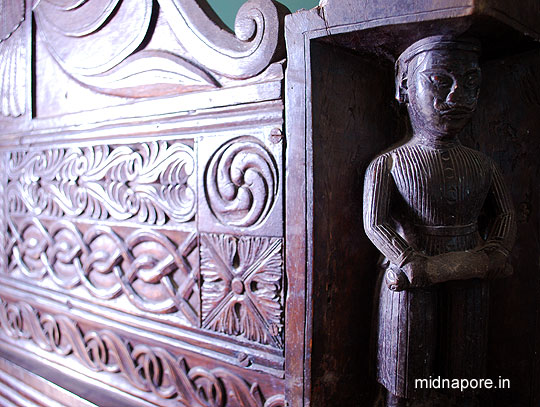 Palanka (Decorated Bed)  Four corners (Legs) of this Palanka has been decorated as four armed guards. Mr. Pinaki Nandan Das Mahapatra is the present owner of this palanka. From his early days he always kept distance from this Palanka as he used to fear these 4 guards as well as the then owner (his father) of this Palanka very much. He never gets an opportunity to use this Palanka from his childhood. But, after his father passed away it was his turn to use the Palanka. Yes, he tried few times to use the Palanka, but he could not sleep well. Guess why? Because of those four guards, every night they used to come in his dreams. So, he decided to use the Palanka for guests. Naturally if you go there as his guest, you will may get an opportunity to rest on it, as I got. Unfortunately those 4 guards never came to my dreams; it seems they only love Mr. Pinaki Nandan Das Mahapatra.  